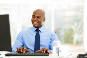 handsome african businessman looking at computer screen